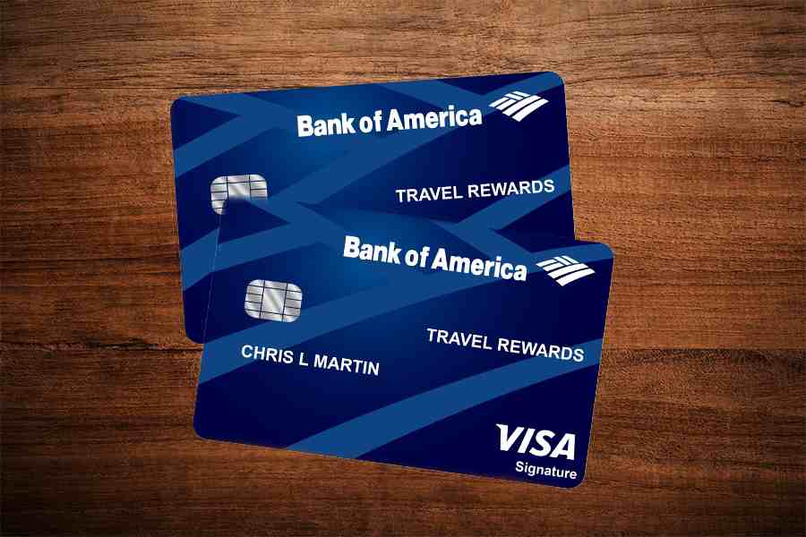 两张美国银行®商务优惠旅游奖励世界万事达卡®，放在木桌上。