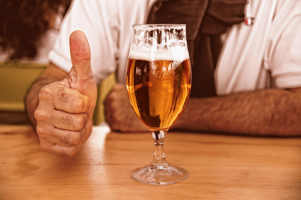 thumbs up with a glass of beer