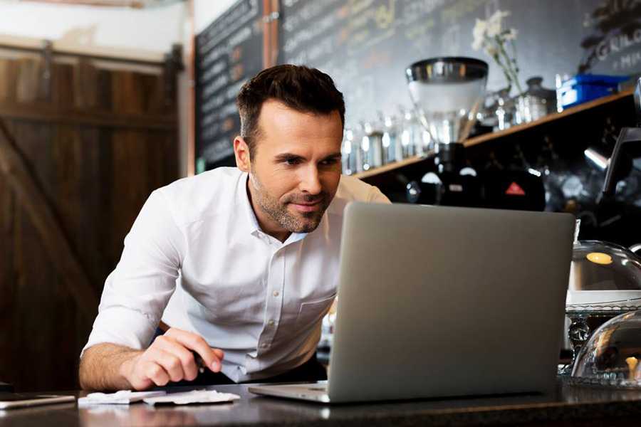 Man enthusiastically working on his laptop.