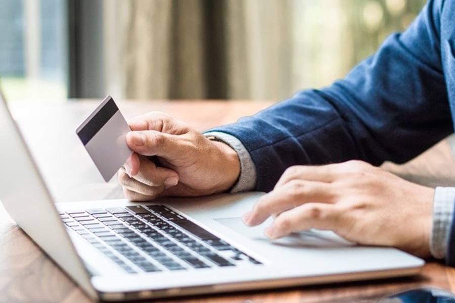 Man checking credit card online using his laptop.
