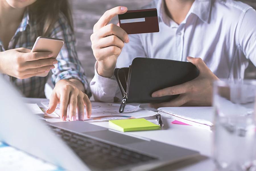 Man and woman checking thier credit card.