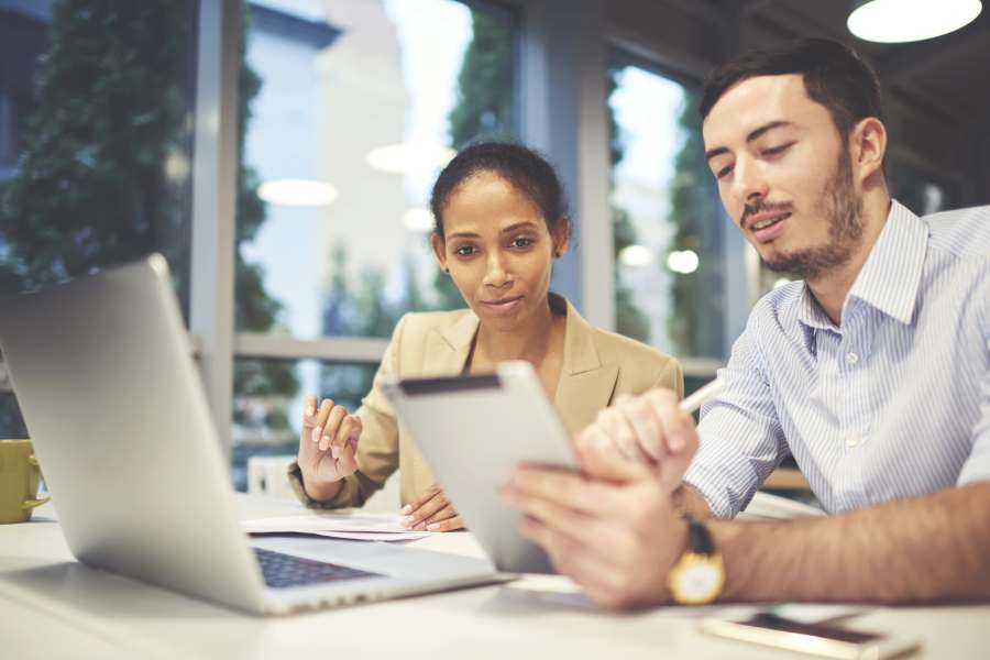 Man and woman watching a video press release.