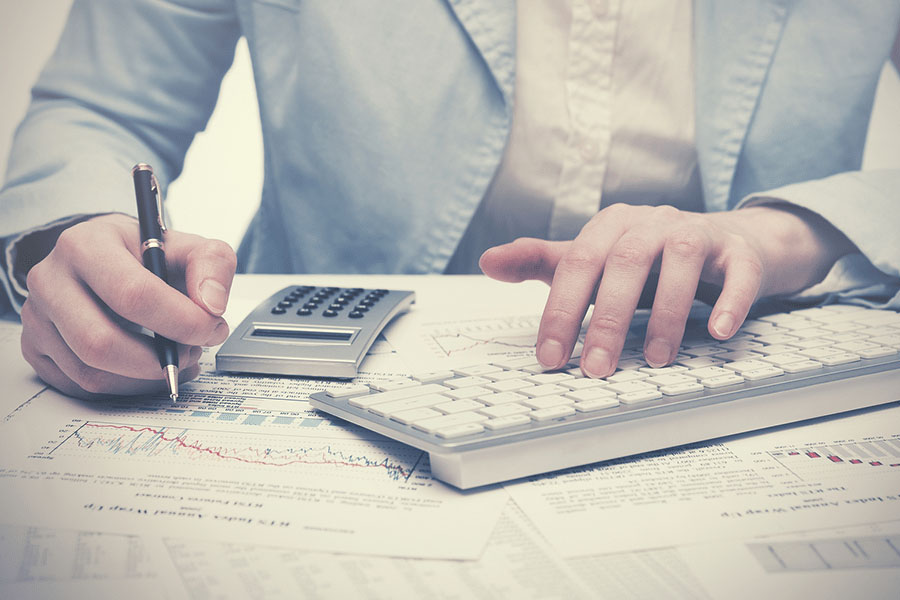 A man using calculator while doing a calculations.