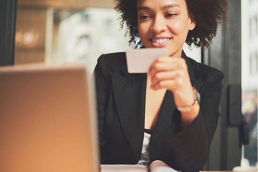 Businesswoman holding a credit card.