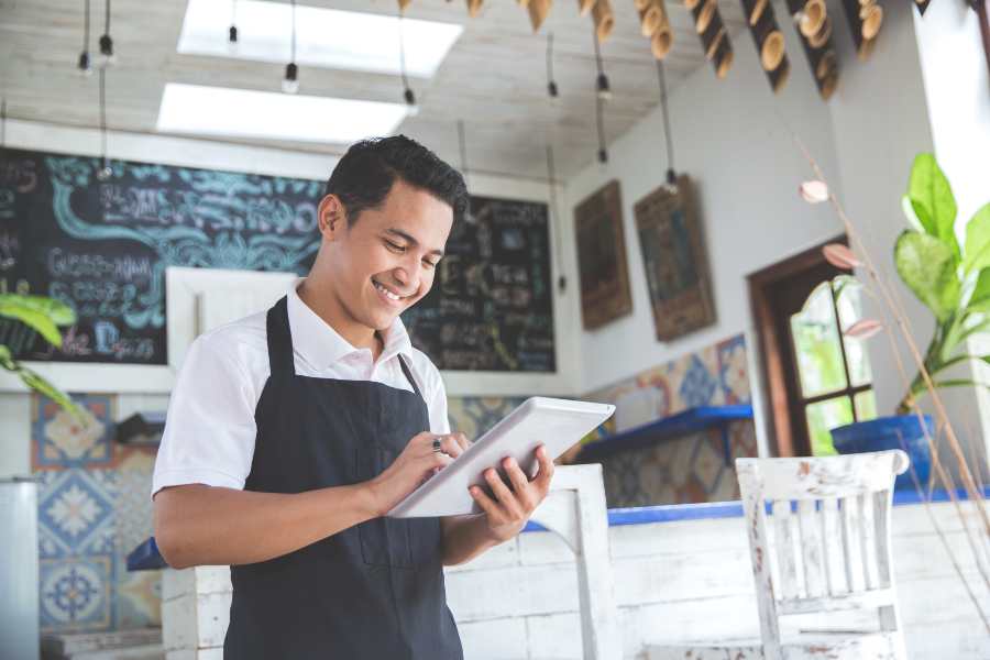 Business owner checking orders in his tablet.