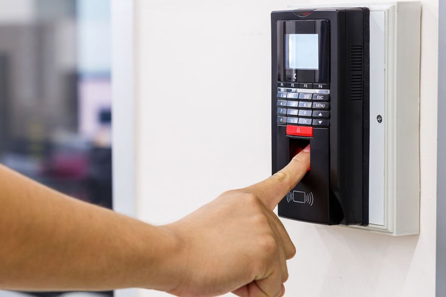 A finger touching the biometric machine.