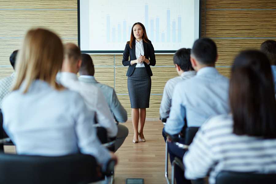 woman presenting in front of audience
