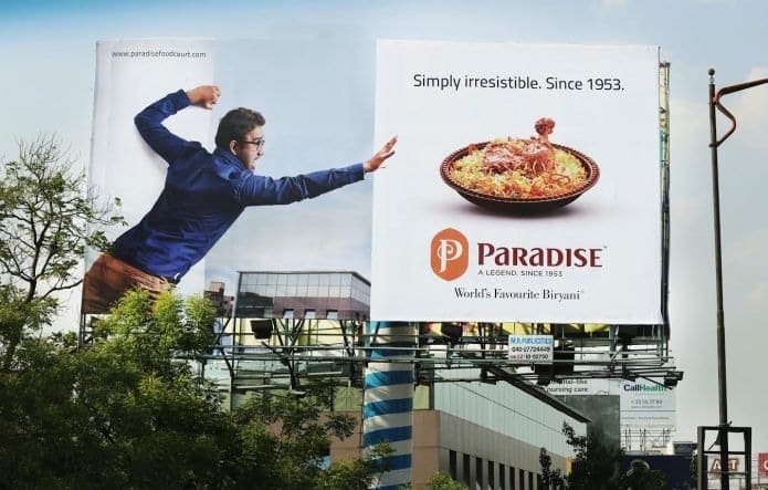 Paradise Food Court ads on a billboard.
