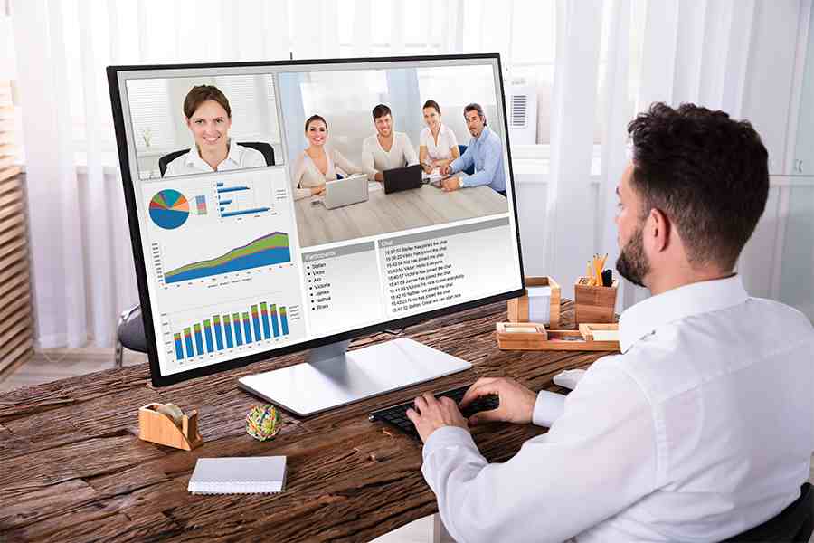 man in front of computer working while having a video conference