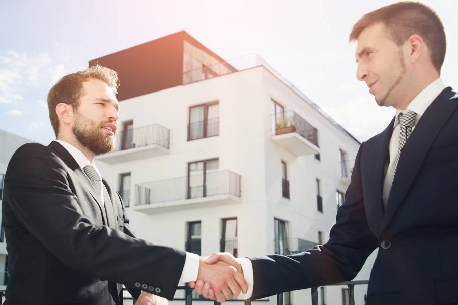 Two businessman shake hands for successful deal.