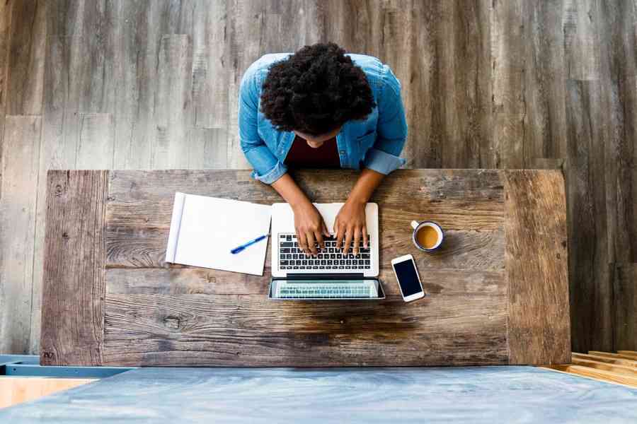 A woman working on her laptop in the office.