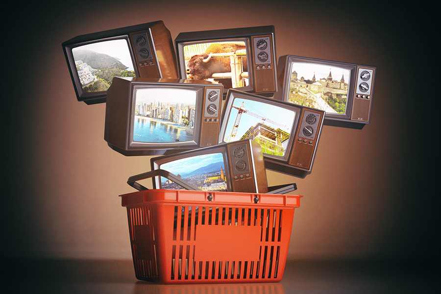 Televisions in a shopping basket.