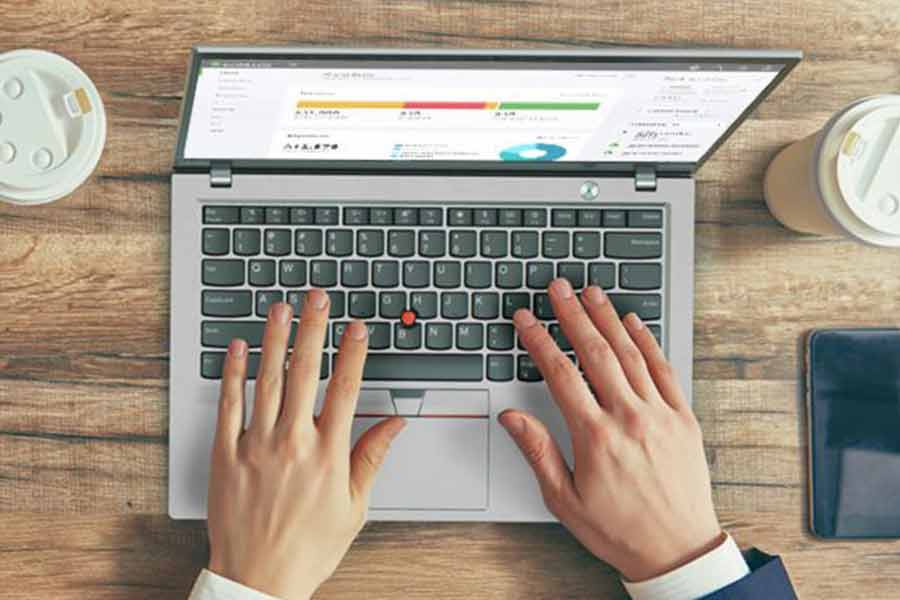 Close up shot of a man's hand typing on a laptop.