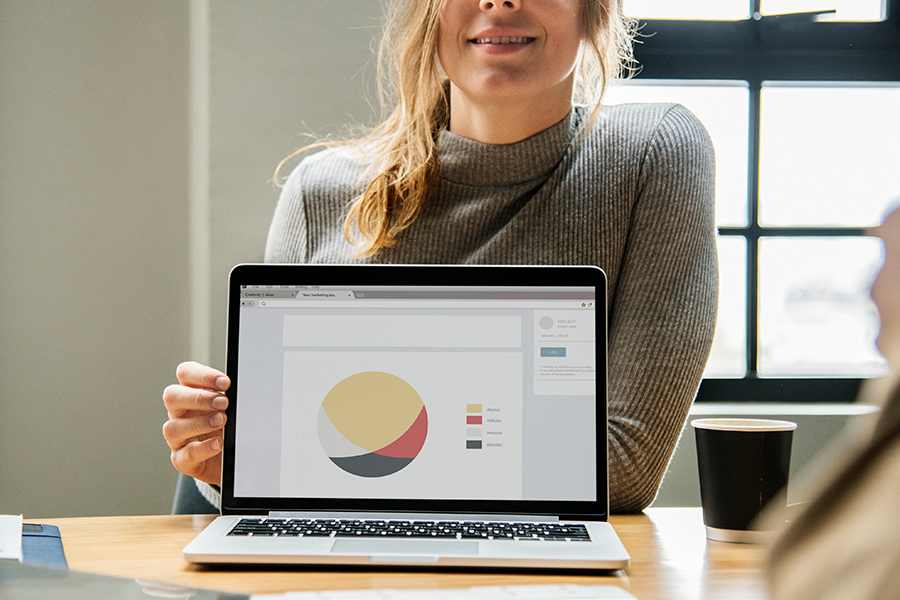 Woman showing a report on her laptop