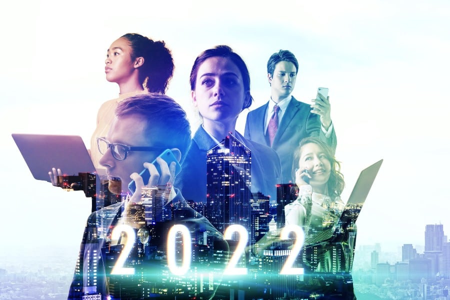 A group of professional men and women with the year 2022 and skyscrapers in the background.