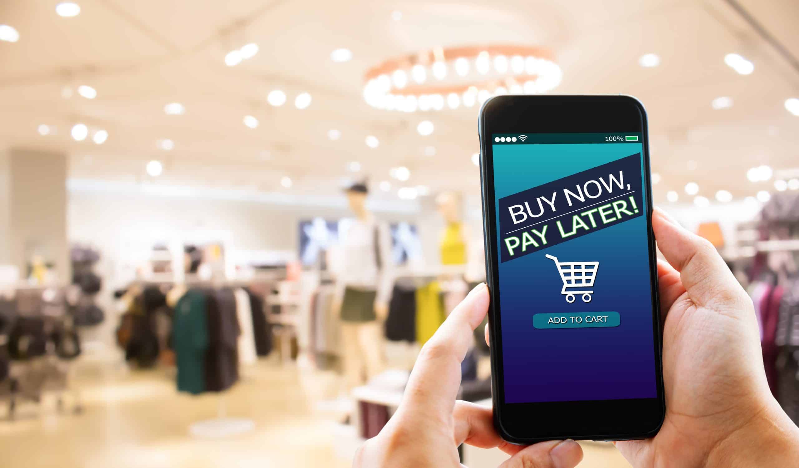 Showing a buyer in a shop with buy now pay later on a mobile screen.