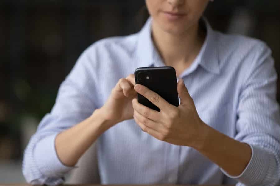 Woman hold look at cellphone screen browse internet.