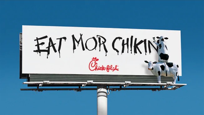 Chick-fil-A billboard ads with cows painting words that say 