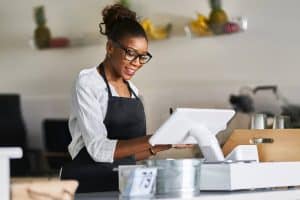 A cashier lady using a pos.