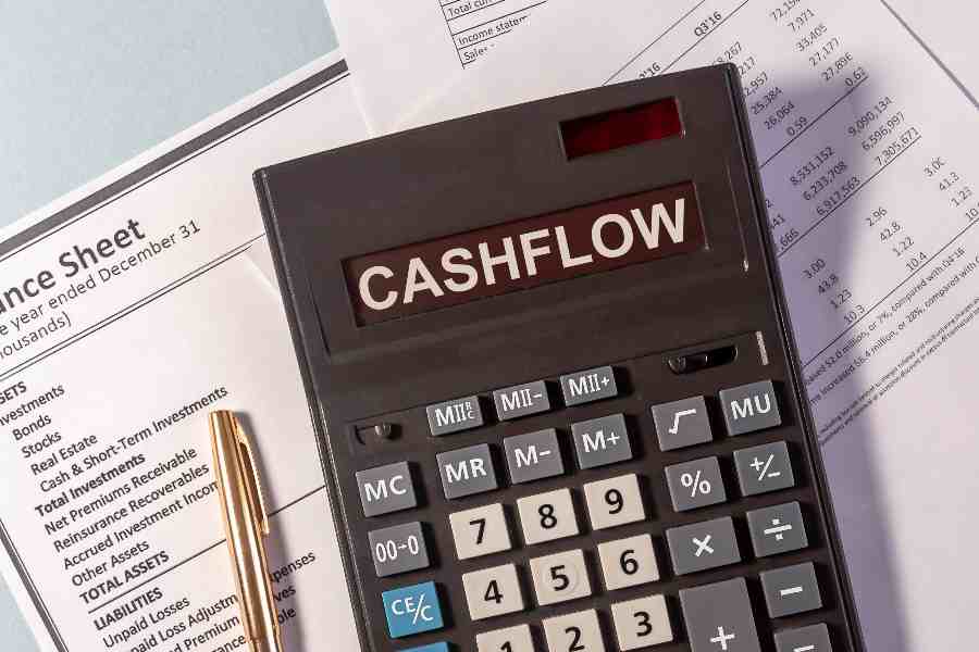 CASHFLOW word on calculator and pen on top of documents.