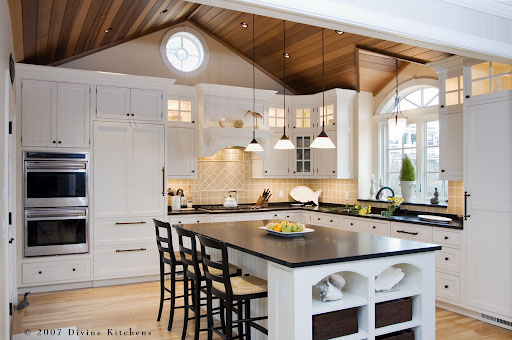Tidy and welcoming kitchen with good lighting and a vaulted bead board ceiling.