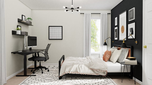 Combination home office and guest room with a desk free of clutter and a nicely made bed.
