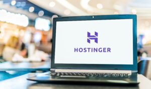 The Hostinger logo is on a laptop screen with a white background.