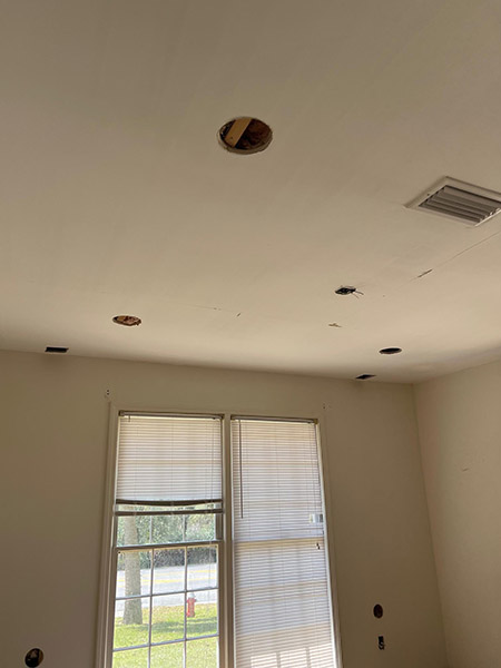 Living room ceiling with holes for recessed lighting.